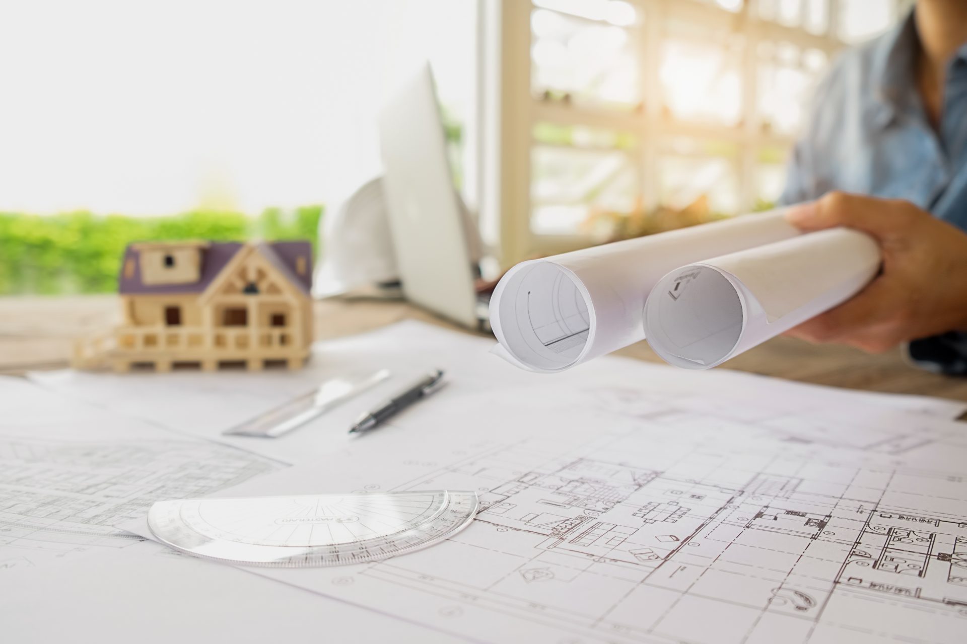hands-of-engineer-working-on-blueprint-construction-concept-engineering-tools-vintage-tone-retro-filter-effect-soft-focus-selective-focus.jpg